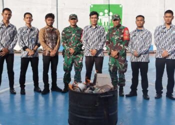 Tim gabungan dari Petugas Pengamanan Lapas Narkotika Pematangsiantar (berbatik) dan personel TNI dari Koramil 14/Raya (berseragam loreng) berpose di depan barang-barang sitaan yang berhasil diamankan dari razia dadakan.(Doc/Foto : Humas Lapas Raya)
